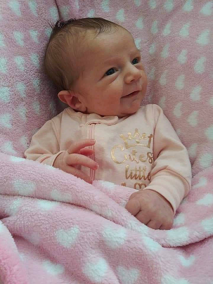 Kaylin is registered to the contest to win money with this photo: baby, baby_products, baby_toddler_clothing, bedding, cheek, child, comfort, face, happy, linens, lip, pattern, person, pink, portrait_photography, product, sitting, skin, sleeve, smile