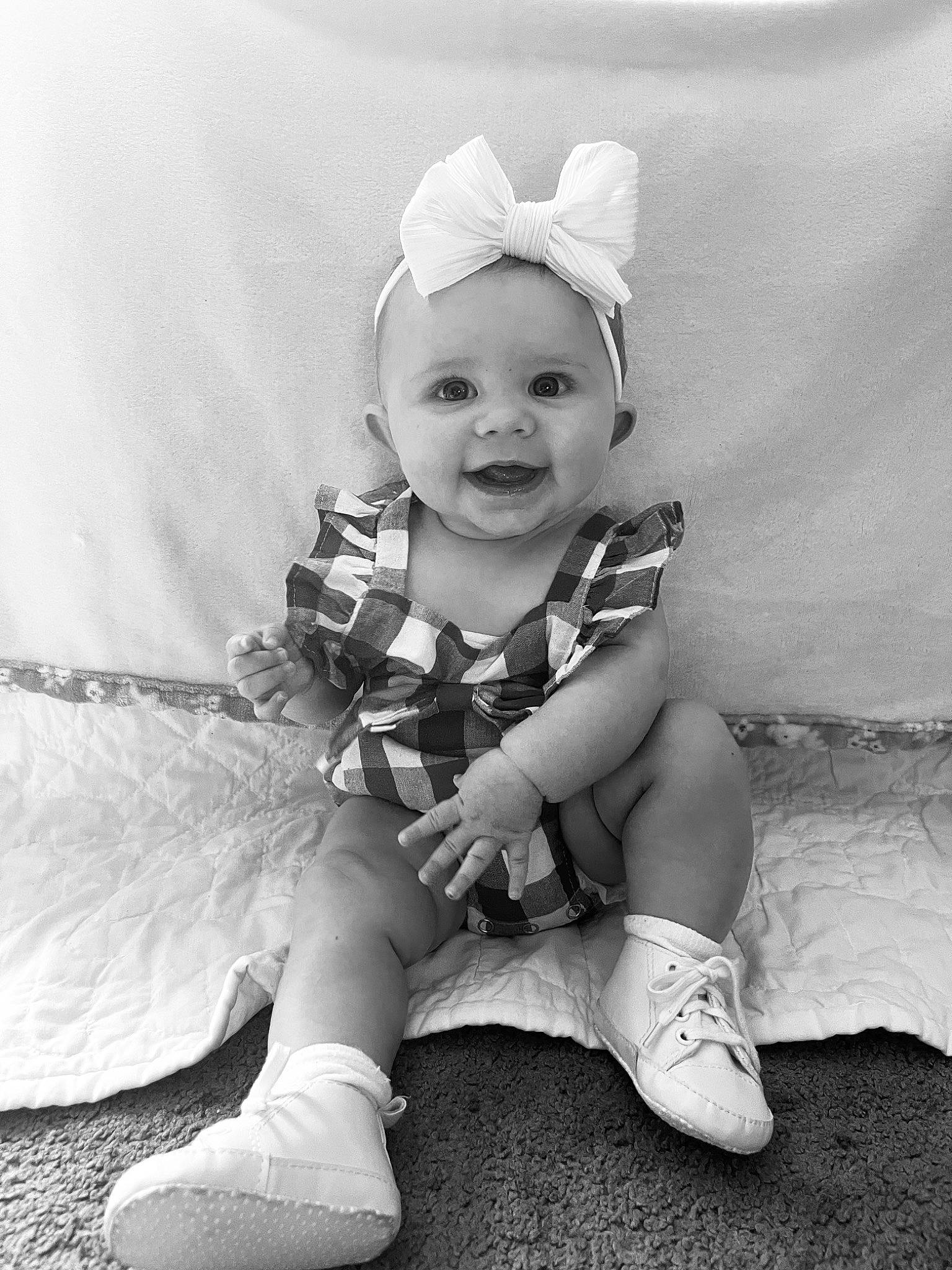 Kinsley Rose is registered to the contest to win money with this photo: baby, baby_toddler_clothing, black_and_white, child, face, fashion_accessory, flash_photography, fun, grass, happy, headband, headpiece, monochrome, monochrome_photography, person, sitting, smile, stock_photography, style, toddler