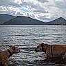 Ecko participe au concours pour gagner de l'argent avec cette photo : animal, canine, cloudy_sky, collar, dog, harness, interaction, lake, landscape, mountain, nature, outdoor, pet, riverbank, scenic, shallow_water, sky, standing, two_animals, water