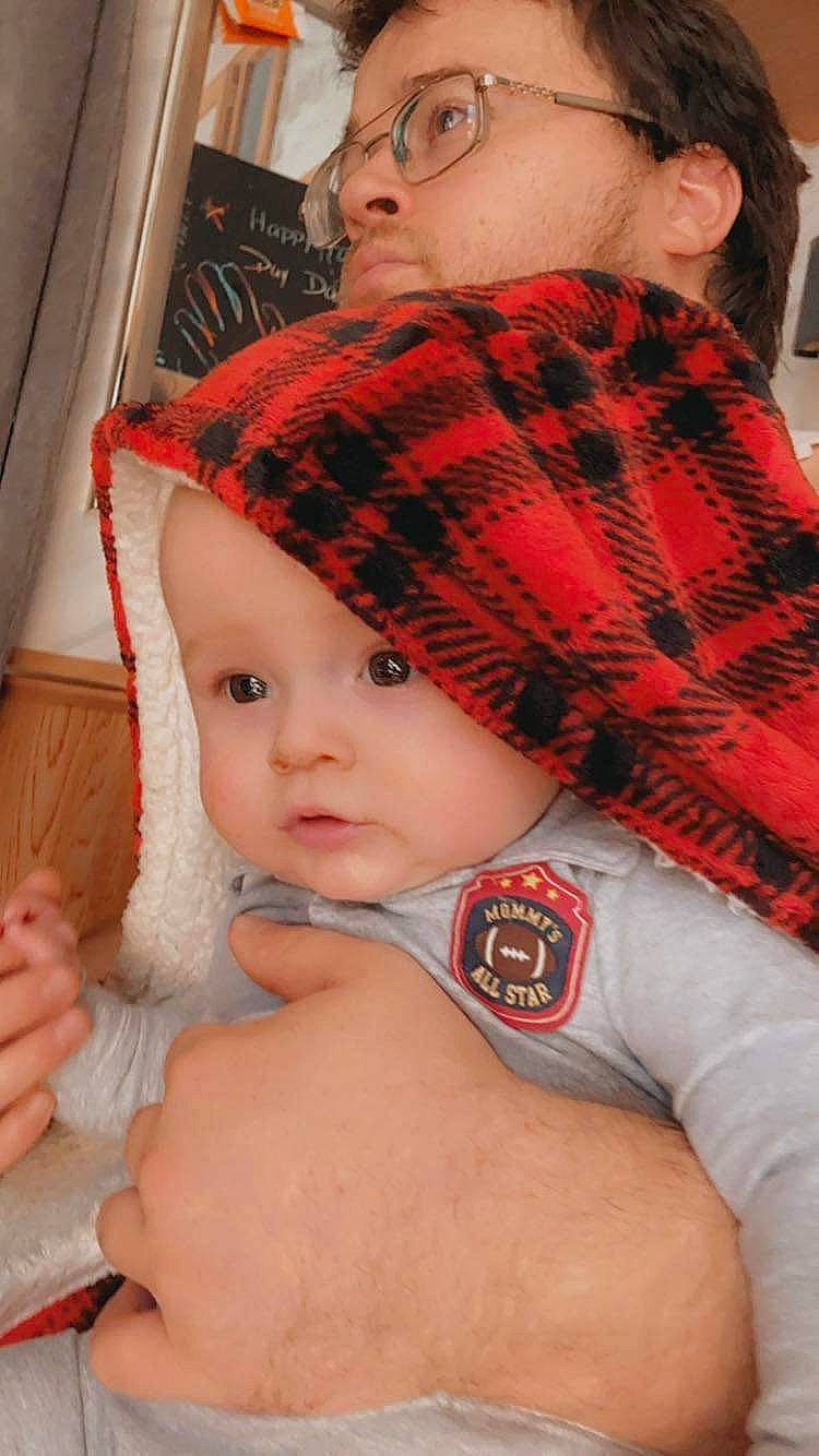Grayson joined the competition — help win amazing prizes! baby, cheek, comfort, elbow, eye, eyelash, face, gesture, head, headwear, human_body, lip, mouth, neck, person, plaid, skin, tartan, textile, thigh