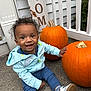 toddler, child, pumpkin, fall, autumn, porch, smiling, happy, sneakers, jacket, pants, concrete, plants, sign, outdoor, curly_hair, seasonal, holiday, decoration, welcome
