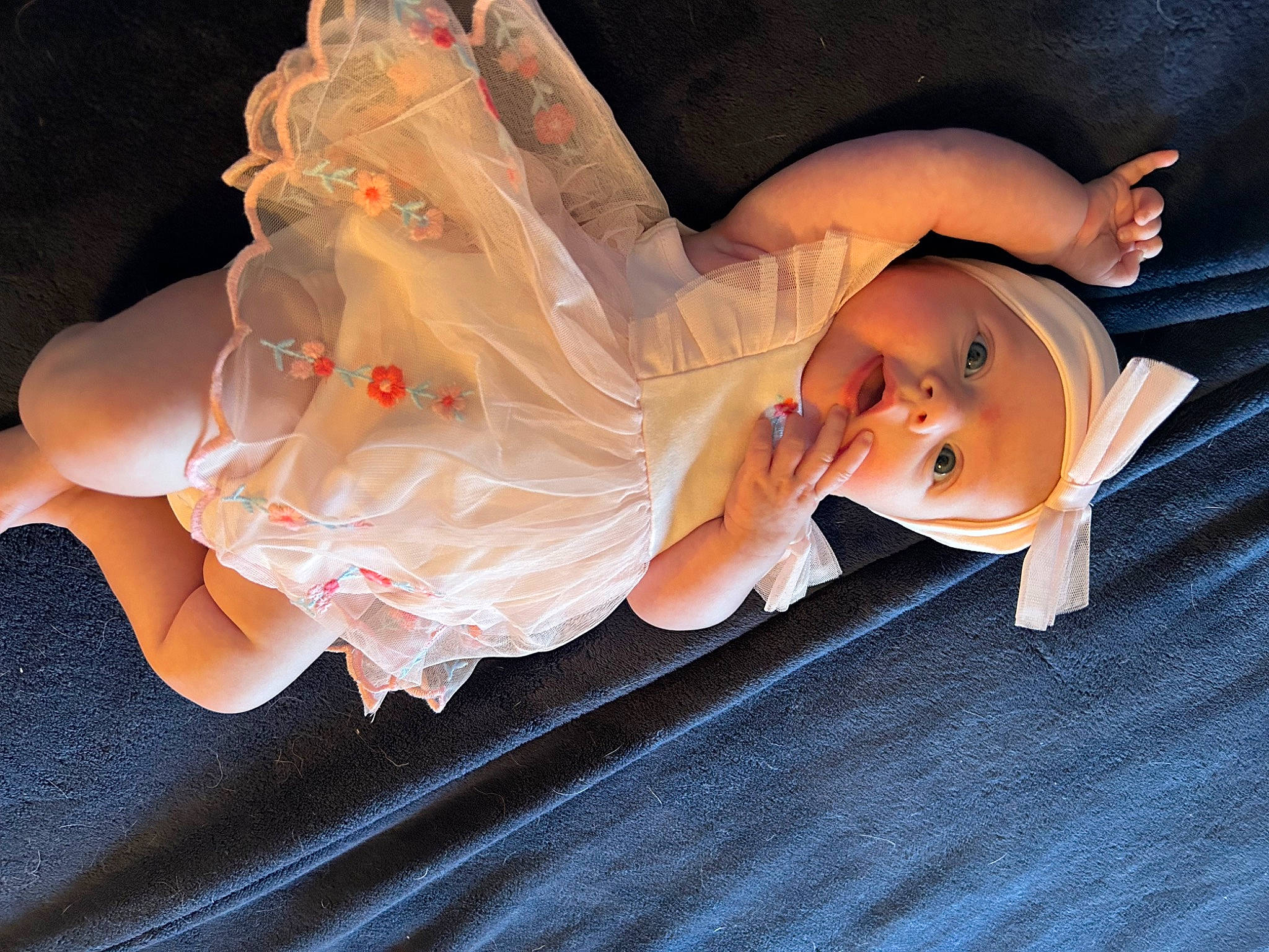 Lucy is registered to the contest to win money with this photo: baby, bridal_accessory, child, costume, dress, event, eye, fashion_accessory, flash_photography, fun, gesture, hand, happy, hat, headpiece, headwear, human_body, human_leg, leg, person