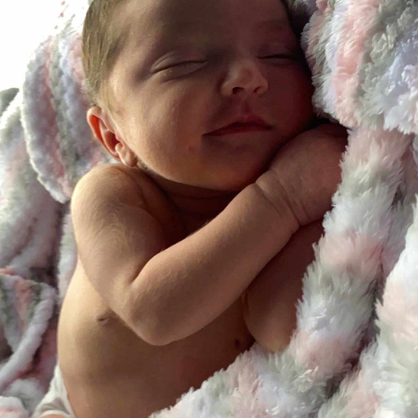 Aviana is registered to the contest to win money with this photo: baby, child, comfort, facial_expression, finger, gesture, hand, happy, head, lip, mammal, nose, people_in_nature, photograph, pink, skin, smile, textile, thumb, toddler