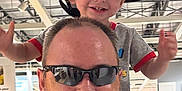 Junior joined the competition — help win amazing prizes! child, toddler, man, beard, sunglasses, hat, cap, smile, happy, shoulders, indoor, store, industrial_ceiling, person, clothing, adult, joy, fun, family, portrait