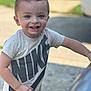 toddler, child, smiling, happy, nike, tshirt, short_sleeve, outdoor, daylight, hairstyle, mohawk, person, young_child, reaching, face, skin, casual_clothing, blurred_background, concrete, grass
