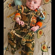 Kevin is registered to the contest to win money with this photo: animal, baby, bird, blanket, camouflage, clothing, cushion, face, furniture, head, homedecor, military, militaryuniform, newborn, pants, person, photography, portrait, quilt, sleeping