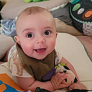 Arlo joined the competition — help win amazing prizes! baby, blanket, child, clothing, colorful, comfort, cushion, cute, face, happy, indoors, infant, lying_down, person, playful, plush_toy, smiling, soft_toys, toddler, young_child