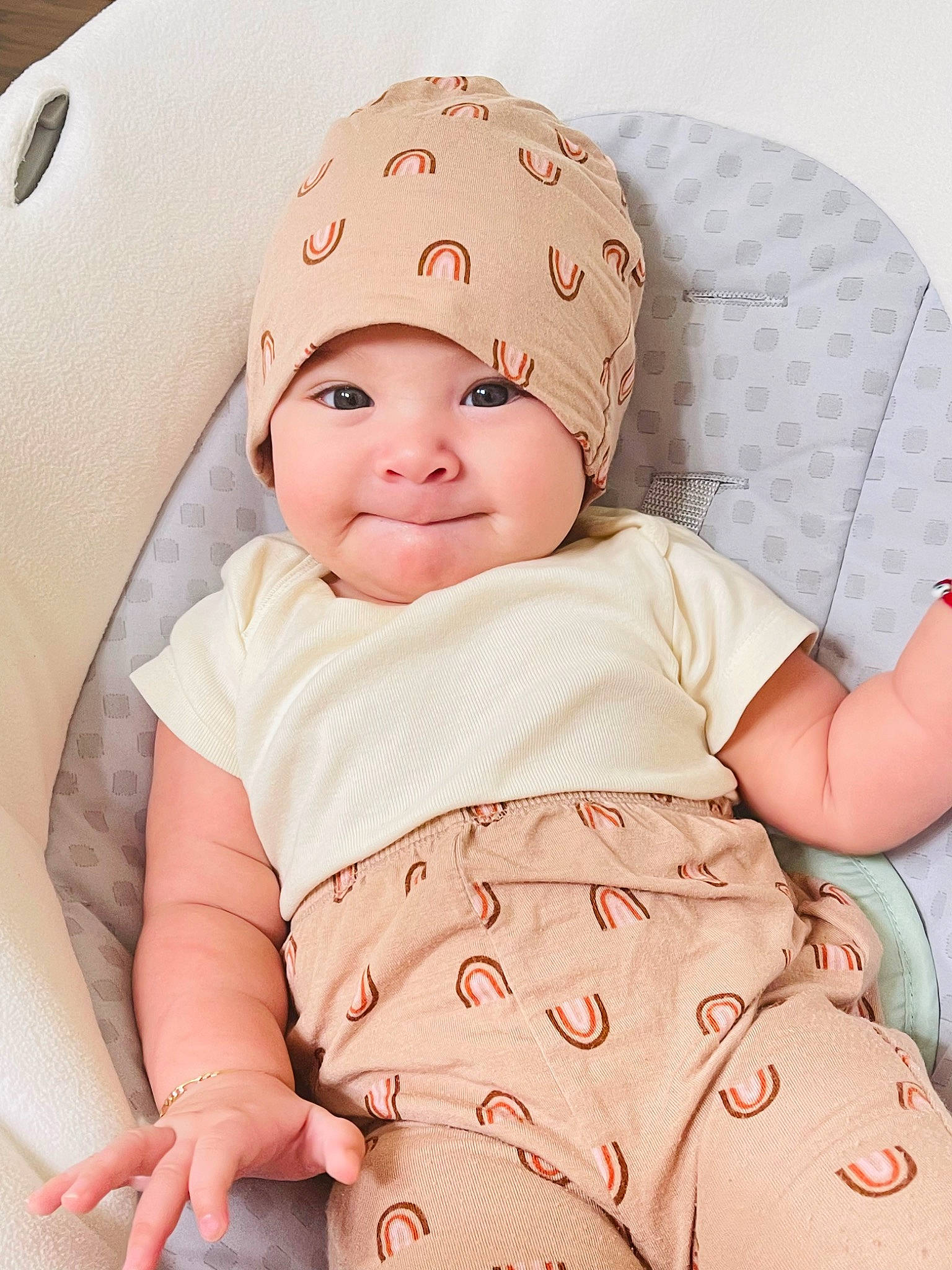 Margaret is registered to the contest to win money with this photo: baby, baby_products, baby_safety, baby_sleeping, baby_toddler_clothing, cap, cheek, child, comfort, face, headwear, linens, pattern, person, pink, product, sitting, skin, sleeve, smile
