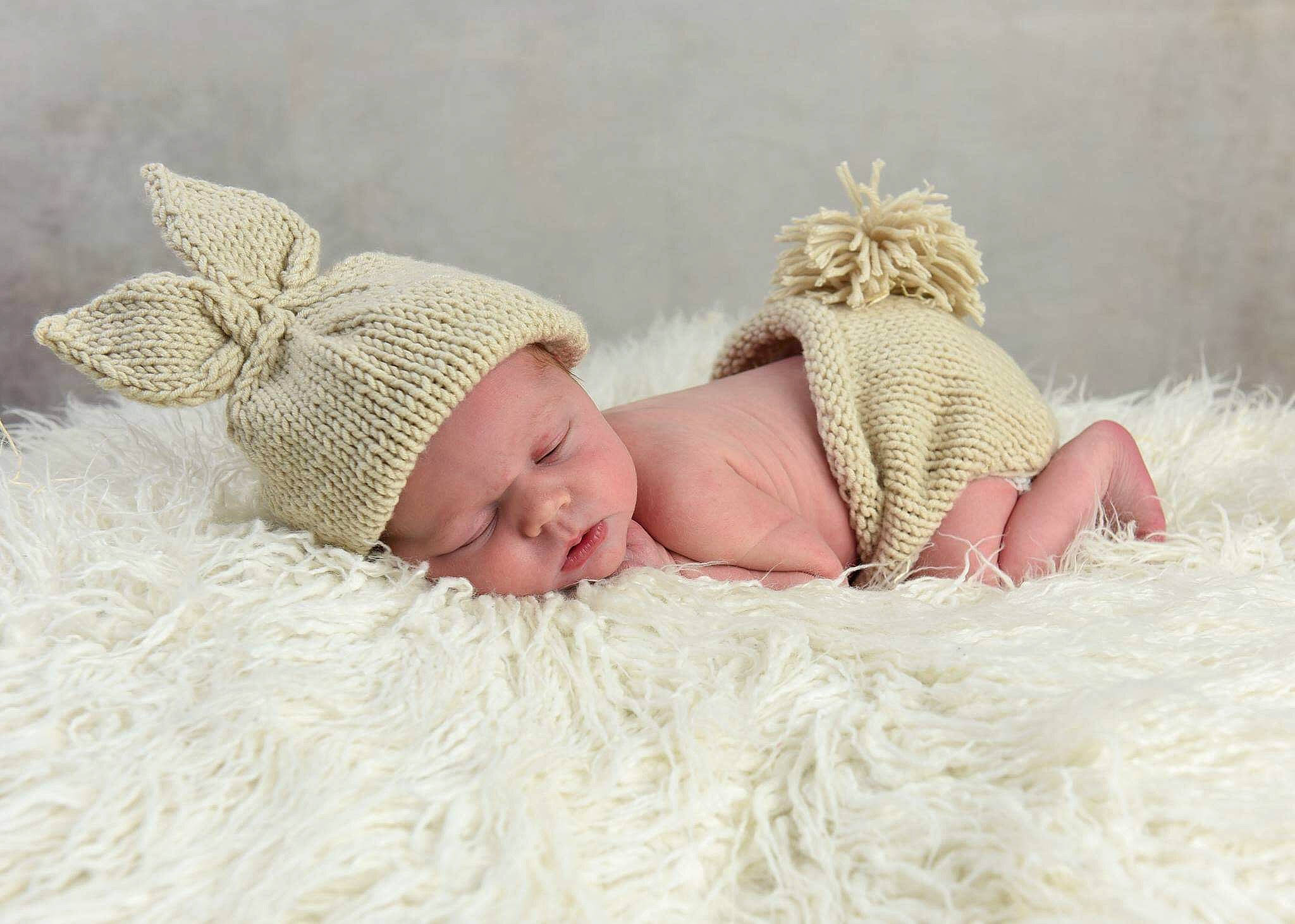 Ebony is registered to the contest to win money with this photo: baby, baby_sleeping, beanie, beige, bonnet, child, fashion_accessory, fur, headgear, knit_cap, person, photograph, photography, playing_in_the_snow, sibling, skin, sleep, toddler, wool