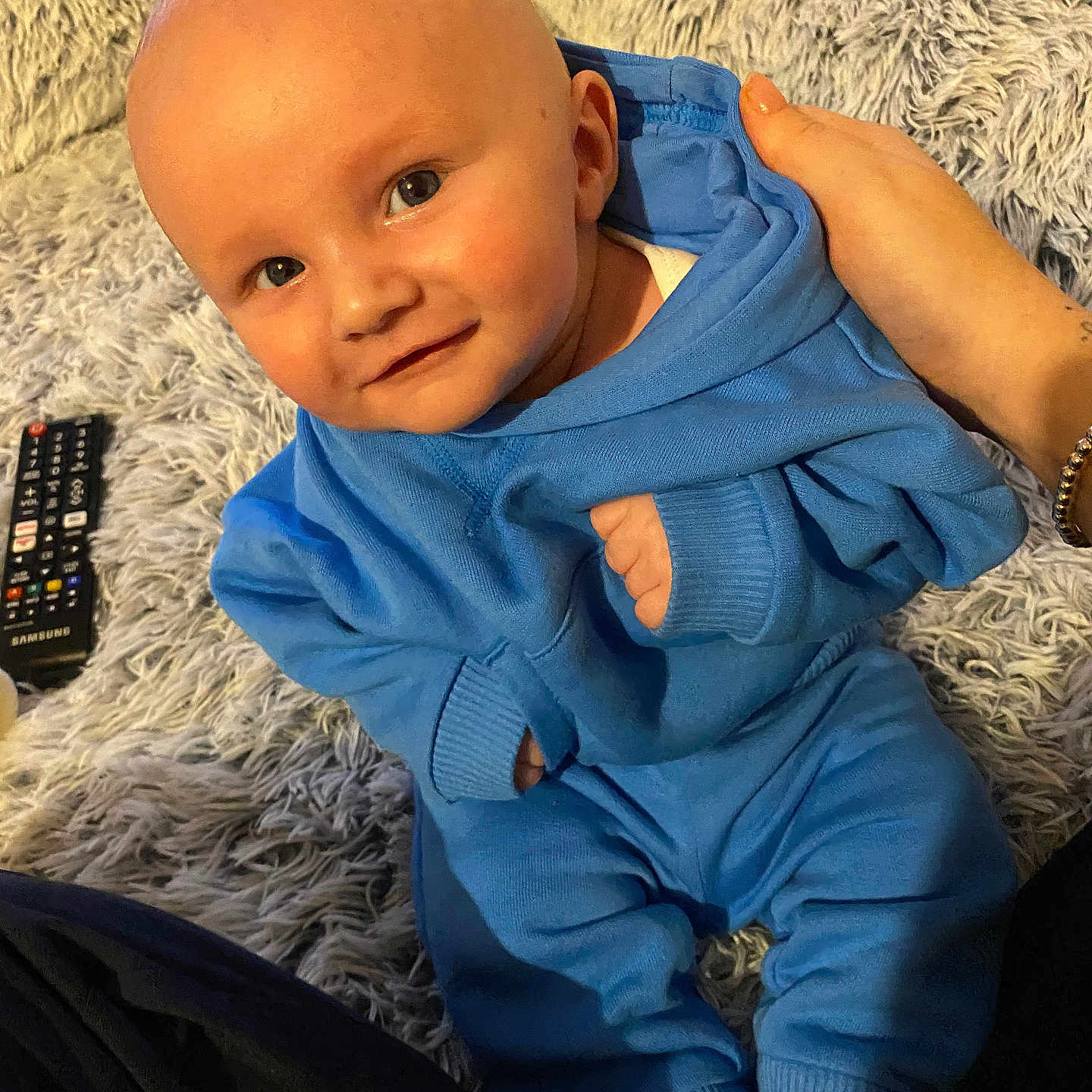 Ronnie joined the competition — help win amazing prizes! baby, bodypart, clothing, coat, couch, electronics, face, finger, furniture, hand, head, jacket, knitwear, newborn, pants, person, photography, portrait, remotecontrol, sweater