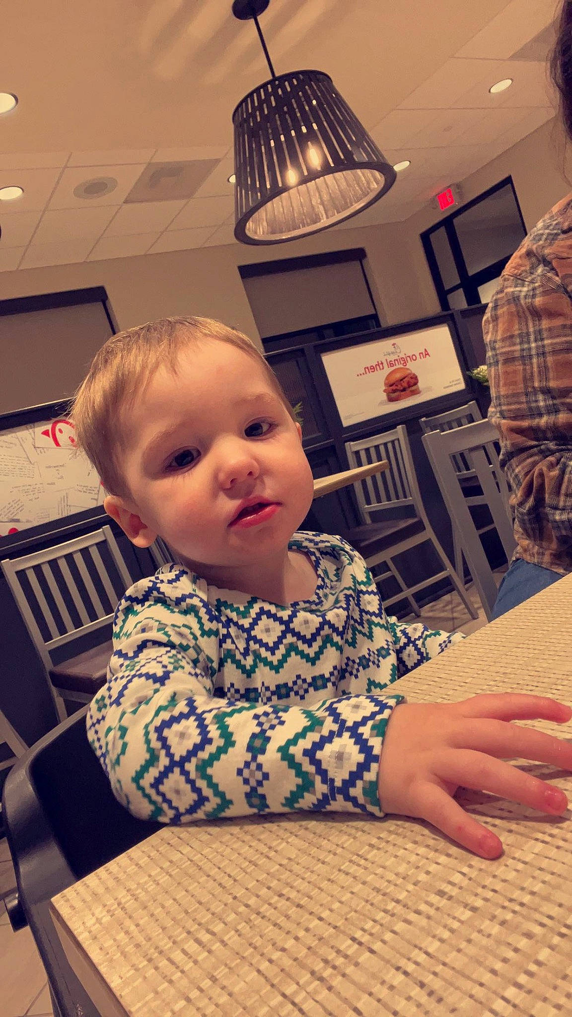 Ryder is registered to the contest to win money with this photo: baby, baby_toddler_clothing, chair, child, comfort, facial_expression, floor, flooring, fun, hairstyle, hand, happy, hardwood, pattern, person, room, sitting, sleeve, t_shirt, toddler