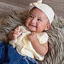 baby, candid, child, closeup, cute, denim_pants, earrings, fashion, floor, fluffy_rug, hands, happy, headband, indoor, infant, lying_down, portrait, skin, smiling, yellow_top