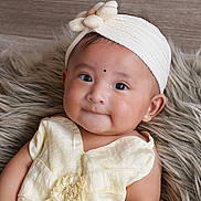 Zanaya is registered to the contest to win money with this photo: baby, child, headband, flower, yellow_clothing, earrings, fluffy_rug, portrait, cute, infant, smile, indoors, soft_lighting, closeup, expression, happy, skin, person, fashion, adorable