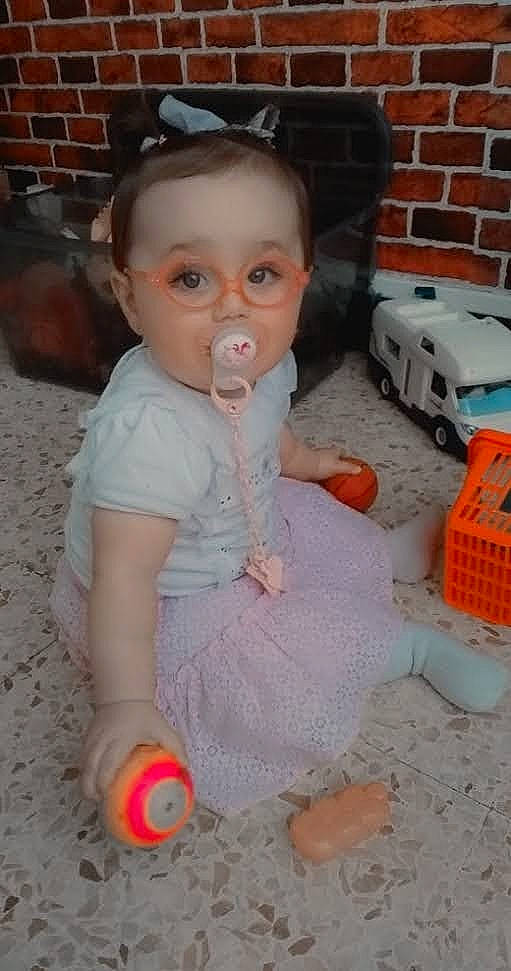 Mila a rejoint le concours — aidez-le/la à gagner de superbes lots ! baby, baby_toddler_clothing, brick, brickwork, chair, cheek, child, dress, eyelash, floor, flooring, fun, hairstyle, nose, orange, person, play, sitting, toddler, toy