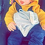 Thymaël a rejoint le concours — aidez-le/la à gagner de superbes lots ! baby, child, car_seat, yellow_hoodie, blanket, tongue_out, blue_pants, white_shoes, infant, casual_clothing, seatbelt, indoors, cute, smiling, playful, young_child, comfort, portrait, face, hands