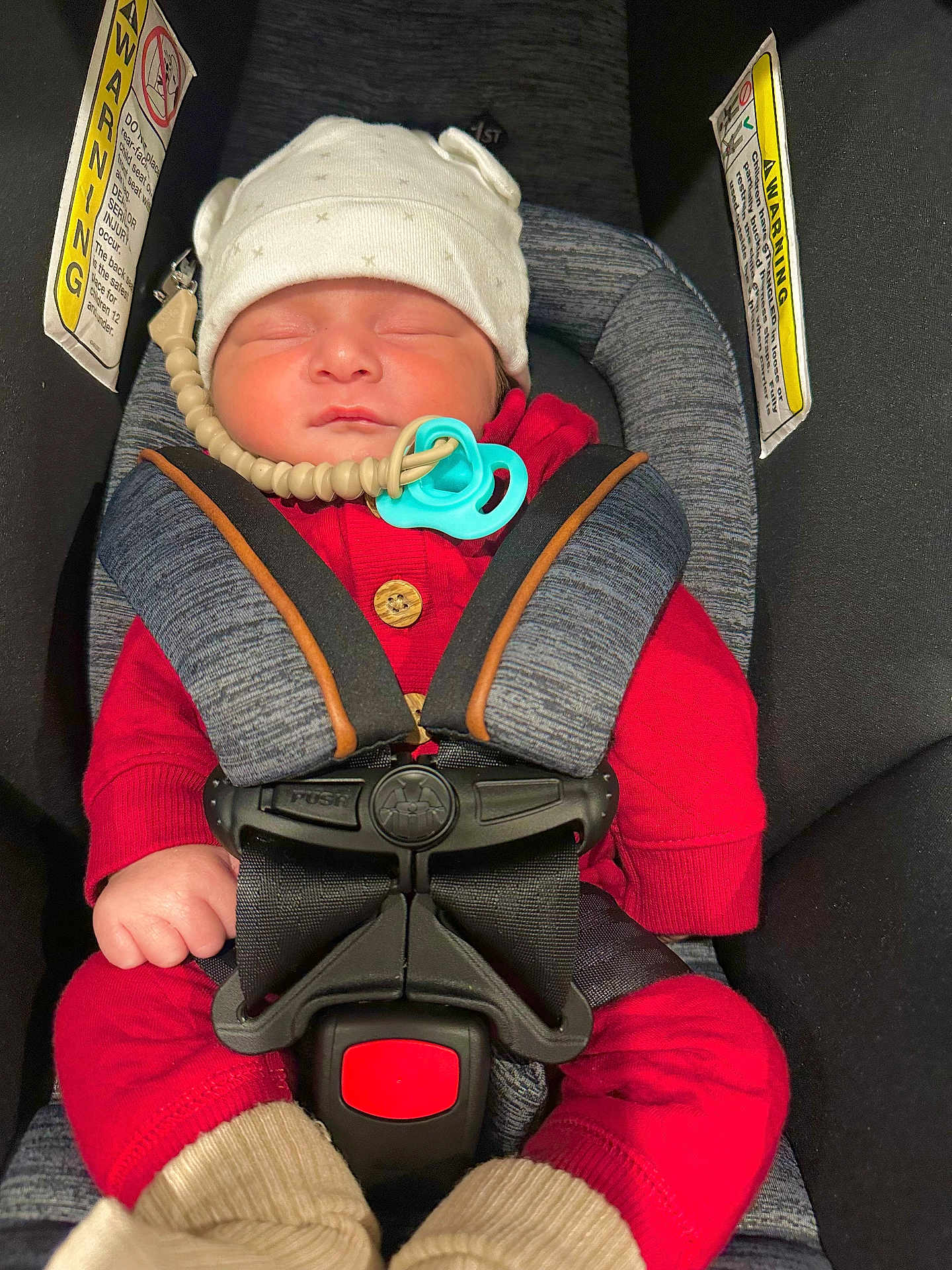 Ian Noah Osorto joined the competition — help win amazing prizes! baby, sleeping, car_seat, red_clothing, white_hat, pacifier, beaded_clip, safety_harness, infant, child, cute, cozy, seatbelt, car_interior, warning_label, hands, headwear, resting, newborn, toddler