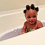 Zákari is registered to the contest to win money with this photo: baby, bantu_knots, bath, bathroom, bathtub, child, clean, cute, hair, happy, indoors, infant, person, playful, skin, smiling, splash, toy, water, young_child