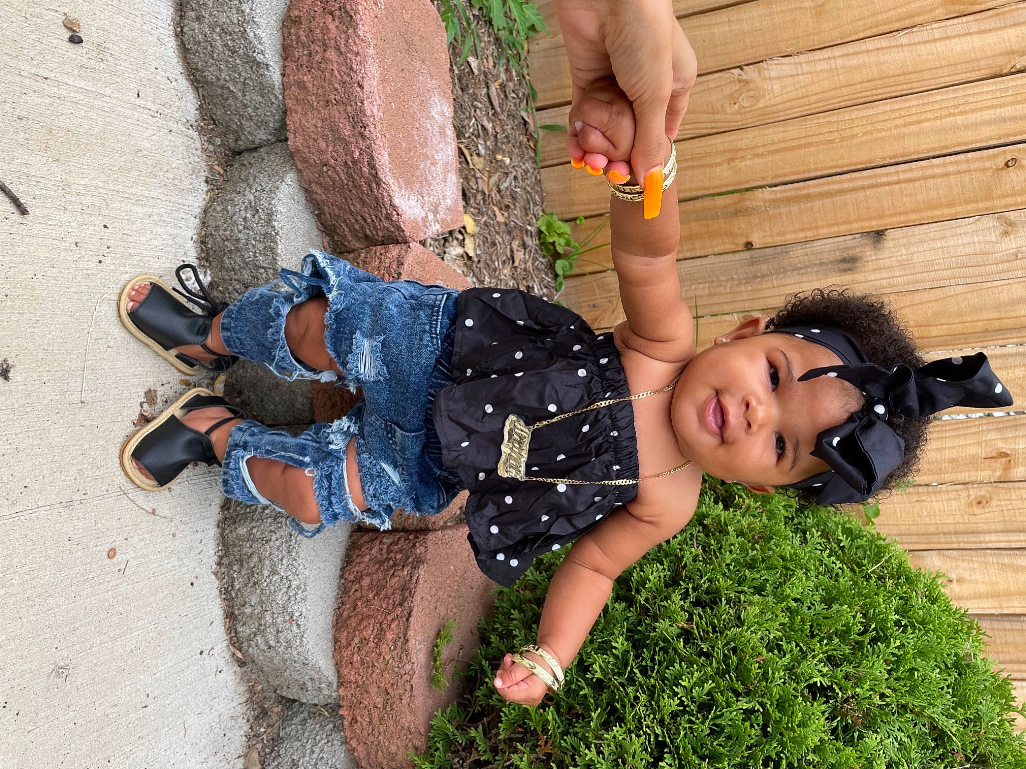 Aminah is registered to the contest to win money with this photo: arm, child, denim, electric_blue, fun, grass, hand, happy, headwear, human_leg, joint, landscape, leisure, people_in_nature, person, play, recreation, sandal, sitting, thigh