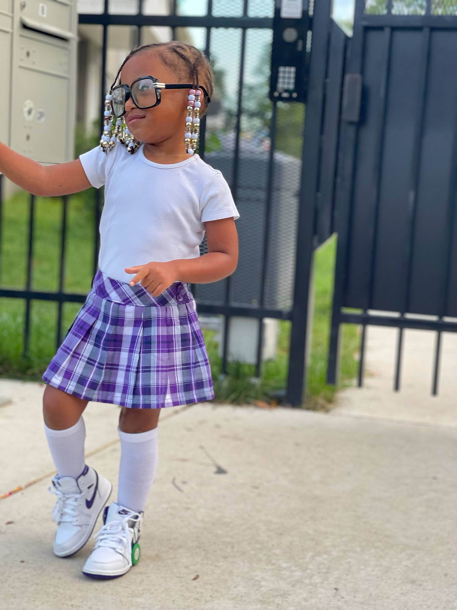 Aubrey is registered to the contest to win money with this photo: electric_blue, eyewear, fashion_accessory, fence, hat, human_leg, knee, leg, magenta, pattern, person, plaid, sleeve, sock, sportswear, street_fashion, sunglasses, t_shirt, tartan, thigh