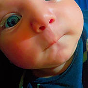 Adam joined the competition — help win amazing prizes! baby, close_up, face, eyes, cheeks, puckered_mouth, infant, blue_clothing, patterned_clothing, skin, expression, portrait, child, cute, young, person, head, indoors, looking, curious