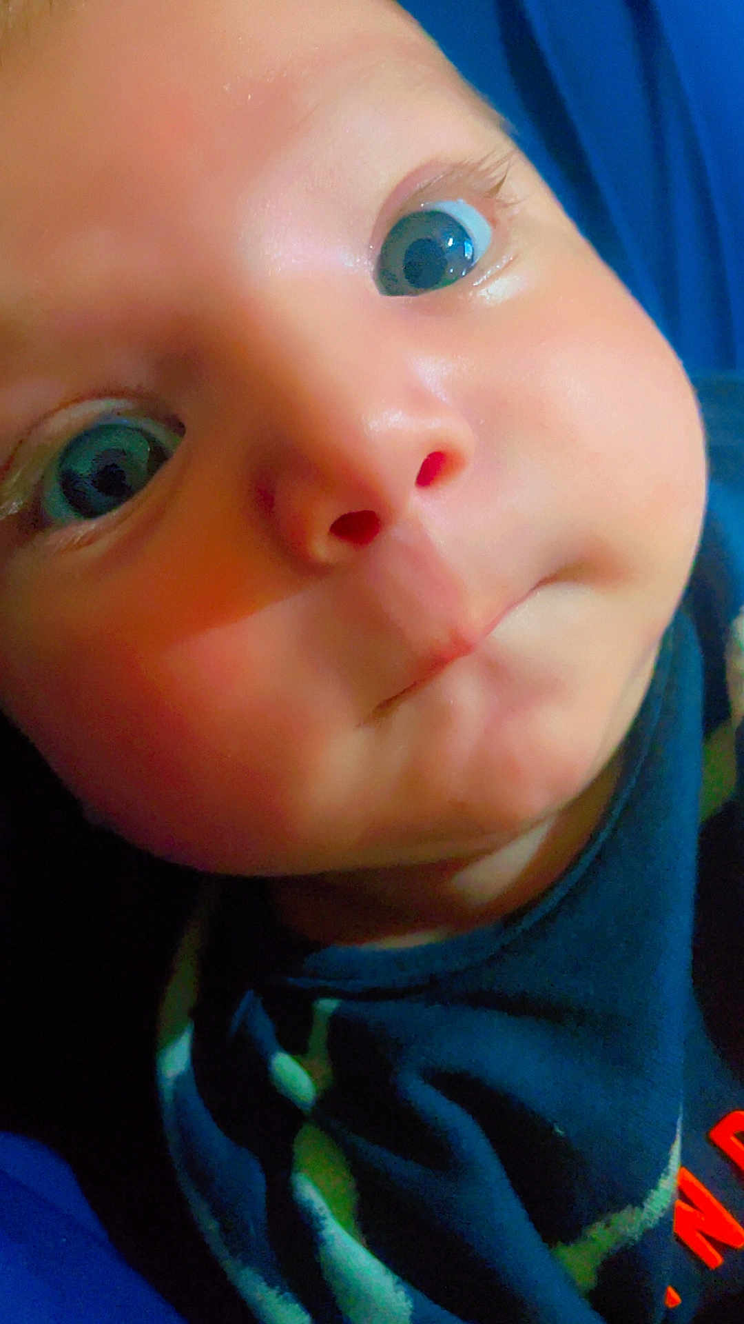 Adam joined the competition — help win amazing prizes! baby, close_up, face, eyes, cheeks, puckered_mouth, infant, blue_clothing, patterned_clothing, skin, expression, portrait, child, cute, young, person, head, indoors, looking, curious