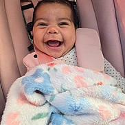 Natalia is registered to the contest to win money with this photo: baby, smile, blanket, car_seat, pink, happy, infant, child, face, clothing, soft_texture, cute, portrait, seatbelt, indoors, cozy, head, expression, warm, comfort