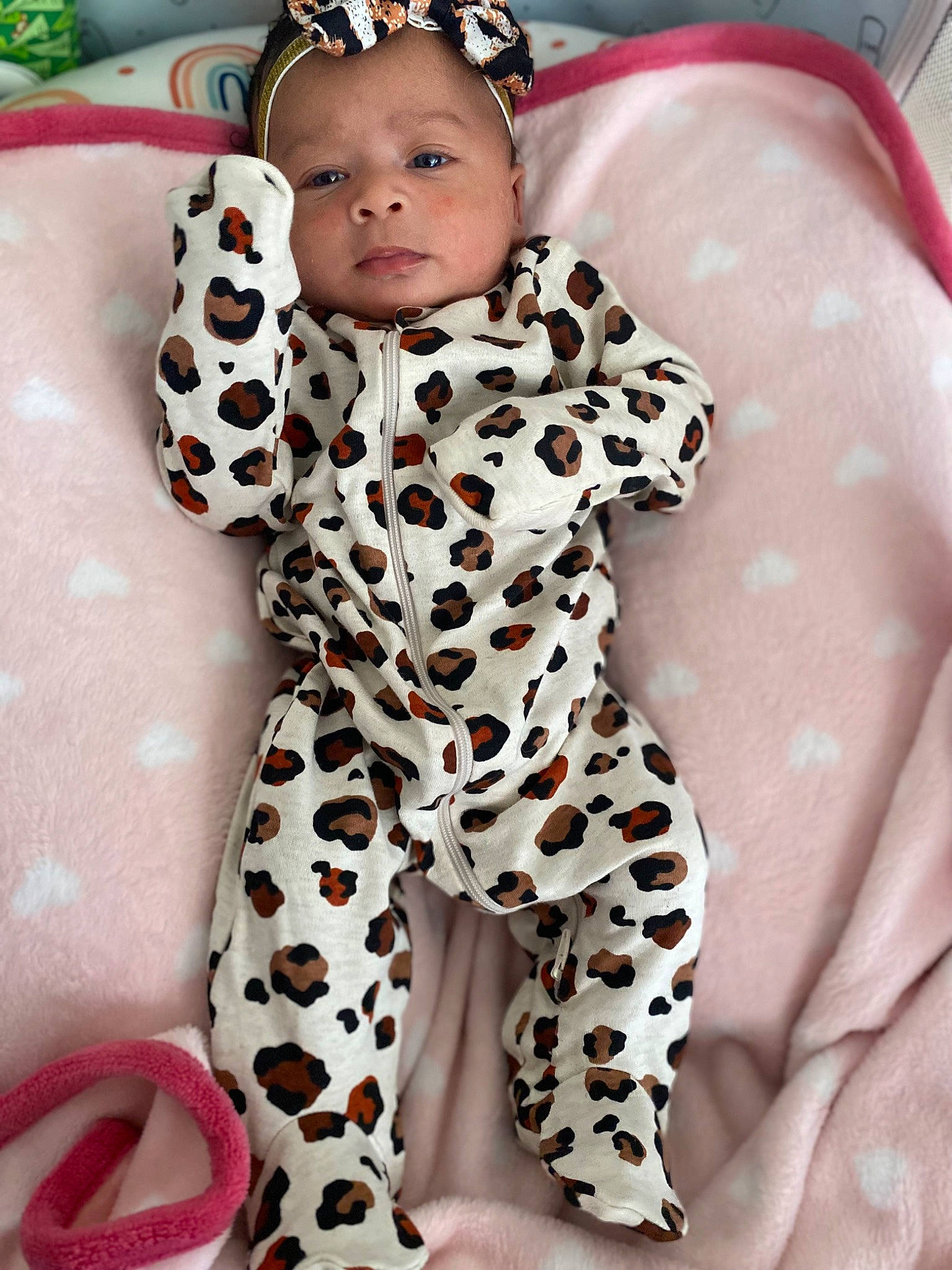 Ahlani is registered to the contest to win money with this photo: baby, baby_toddler_clothing, carmine, child, facial_expression, flooring, leg, mammal, military_camouflage, pattern, person, personal_protective_equipment, pink, skin, sleeve, stuffed_toy, suit, textile, thigh, toddler