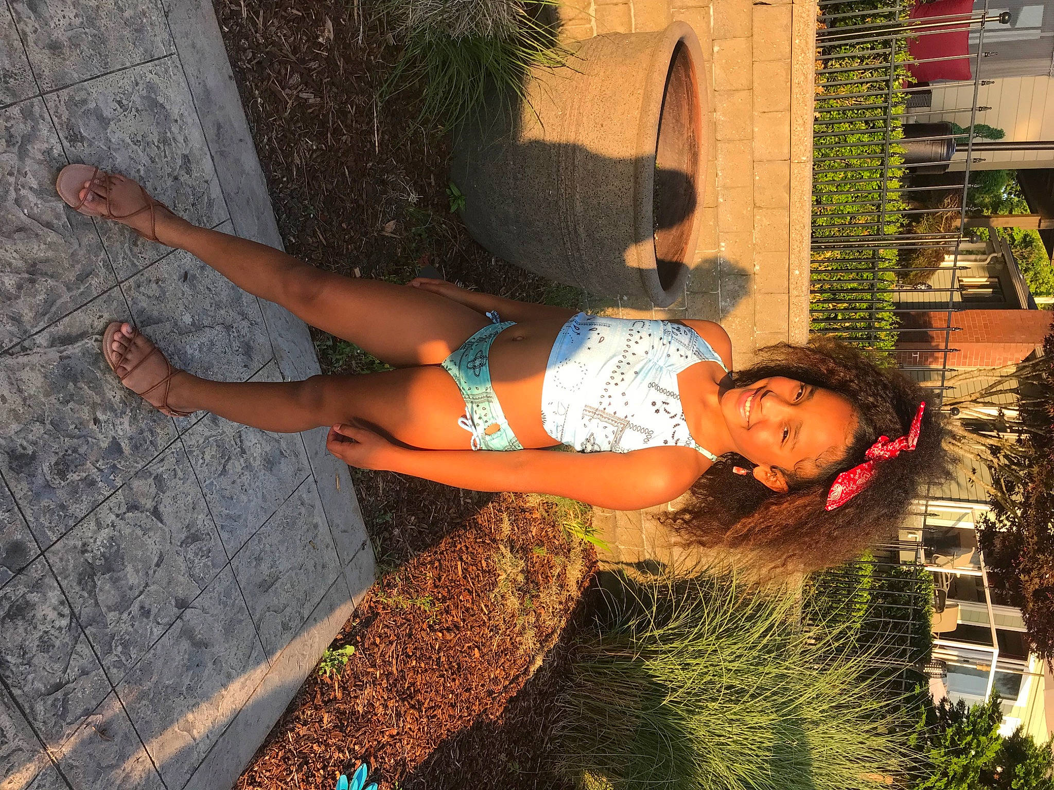 Avianna is registered to the contest to win money with this photo: abdomen, calf, denim, electric_blue, foot, fun, grass, happy, human_leg, joy, knee, leg, leisure, orange, people_in_nature, person, plant, shorts, t_shirt, thigh