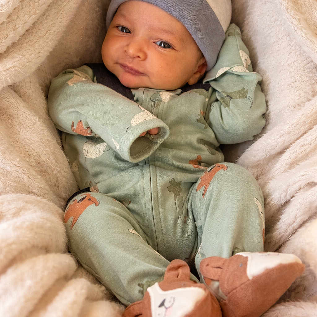 Shaurya is registered to the contest to win money with this photo: animal_print, baby, blanket, cap, child, comfortable, cozy, cute, face, hand, indoors, infant, newborn, onesie, portrait, resting, sleepwear, slippers, smile, soft_texture