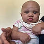 Empress is registered to the contest to win money with this photo: baby, bib, casual, child, clothing, curious, cute, expression, face, hand, holding, indoor, infant, looking, onesie, person, portrait, seated, skin, young