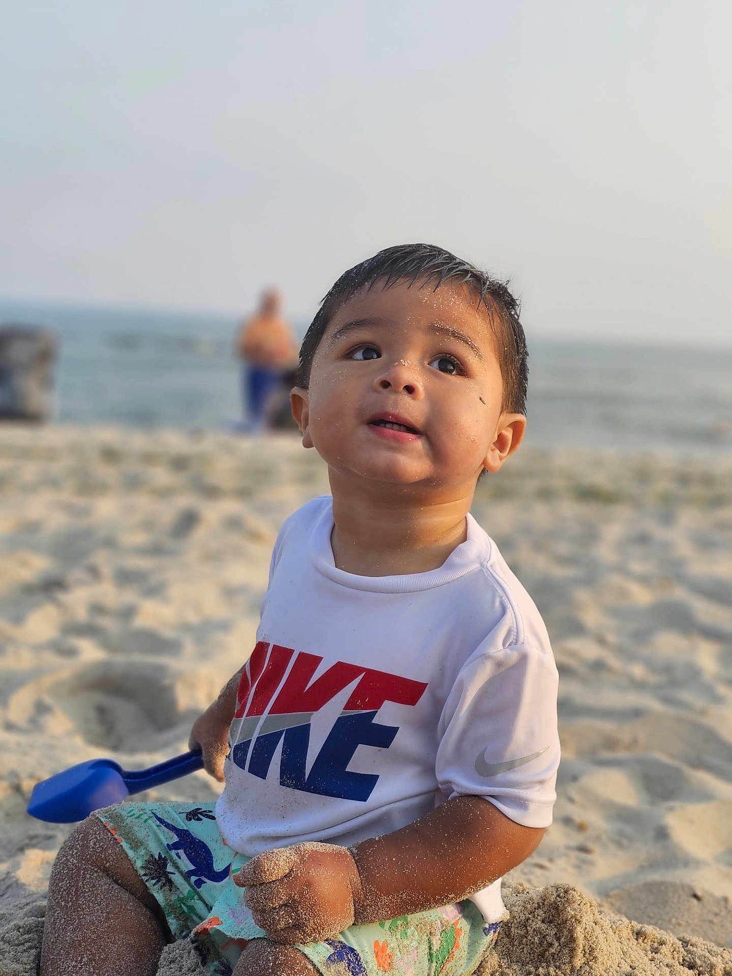 Adan joined the competition — help win amazing prizes! beach, beachwear, boy, child, clothing, coast, face, head, male, nature, outdoors, person, photography, portrait, sea, shoreline, sitting, summer, t_shirt, water