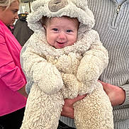 Storey joined the competition — help win amazing prizes! baby, child, person, costume, plush, cute, smile, face, hand, clothing, adult, sweater, tent, indoor, people, woman, pink_jacket, holding, warm, fuzzy