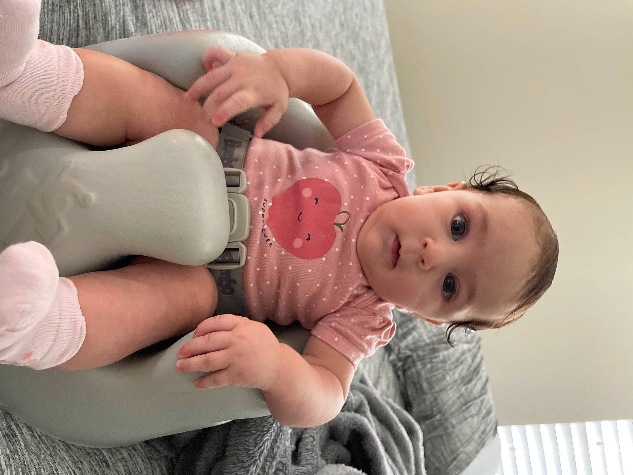 Juliette is registered to the contest to win money with this photo: arm, baby, baby_toddler_clothing, cheek, child, dress, eyelash, finger, gesture, hand, happy, human_body, joint, leg, mouth, nail, person, pink, skin, sleeve