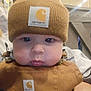 Easton joined the competition — help win amazing prizes! baby, infant, child, beanie, knit_hat, carhartt_label, overalls, bib, chubby_cheeks, eyes, lips, close_up, portrait, indoor, store, wooden_railing, soft_lighting, brown_clothing, adorable, casual_clothing