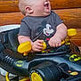 Easton joined the competition — help win amazing prizes! baby, infant, smiling, laughing, chubby_cheeks, mickey_mouse, batman_logo, walker_toy, toy_car, gray_tshirt, yellow, black, hands, face, head, wooden_background, seat, closeup, playful, indoors