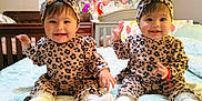 Lyanna And Leslie joined the competition — help win amazing prizes! baby, twins, matching_outfits, headband, leopard_print, smiling, sitting, bed, nursery, crib, bedding, baby_mobile, teddy_bear_wall, cute, indoor, portrait, socks, hands_up, decorative_wall, happy