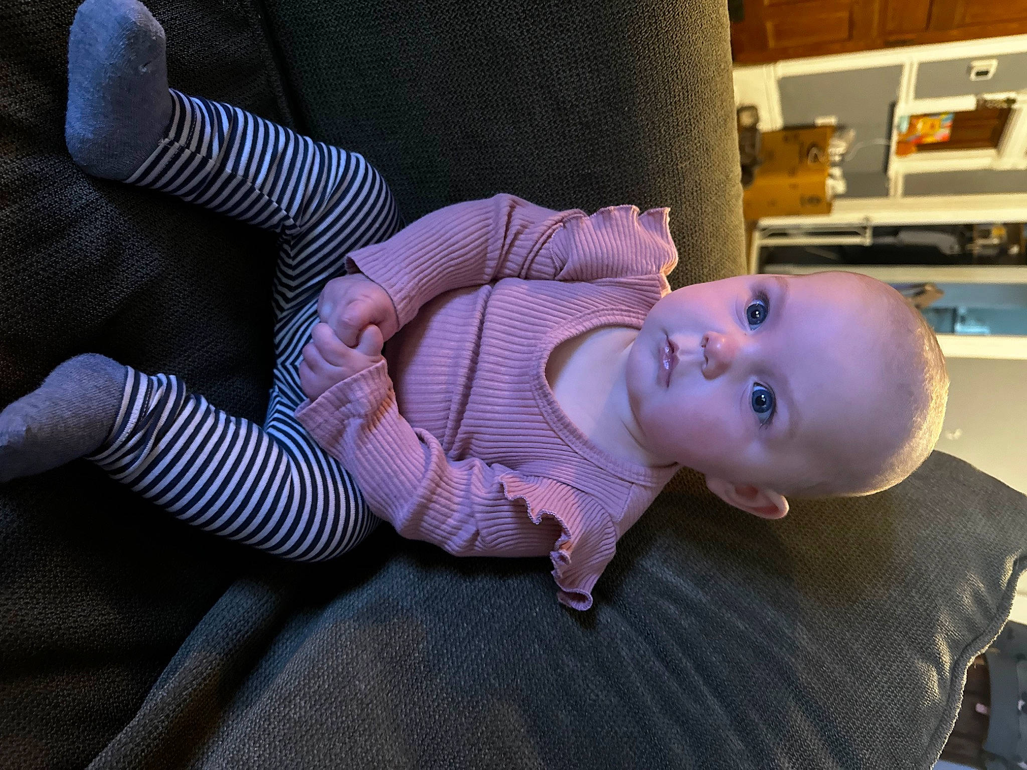 Xaviah is registered to the contest to win money with this photo: baby, baby_toddler_clothing, cheek, child, comfort, flooring, home_appliance, human_body, human_leg, mammal, pattern, person, product, purple, shelf, sitting, skin, smile, thigh, toddler