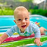 baby, infant, smiling, blue_eyes, pool, inflatable, float, water, outdoor, summer, child, play, colorful, happy, crawling, skin, face, greenery, daylight, toy