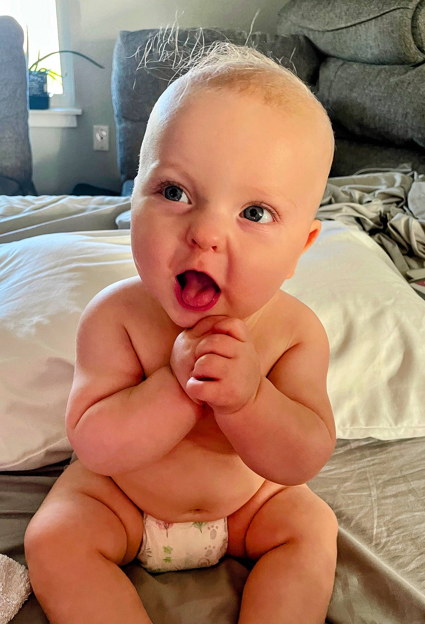 George is registered to the contest to win money with this photo: baby, cheek, comfort, eye, eyebrow, finger, gesture, happy, human_body, leg, lip, mouth, neck, nose, person, pink, skin, smile, stomach, textile