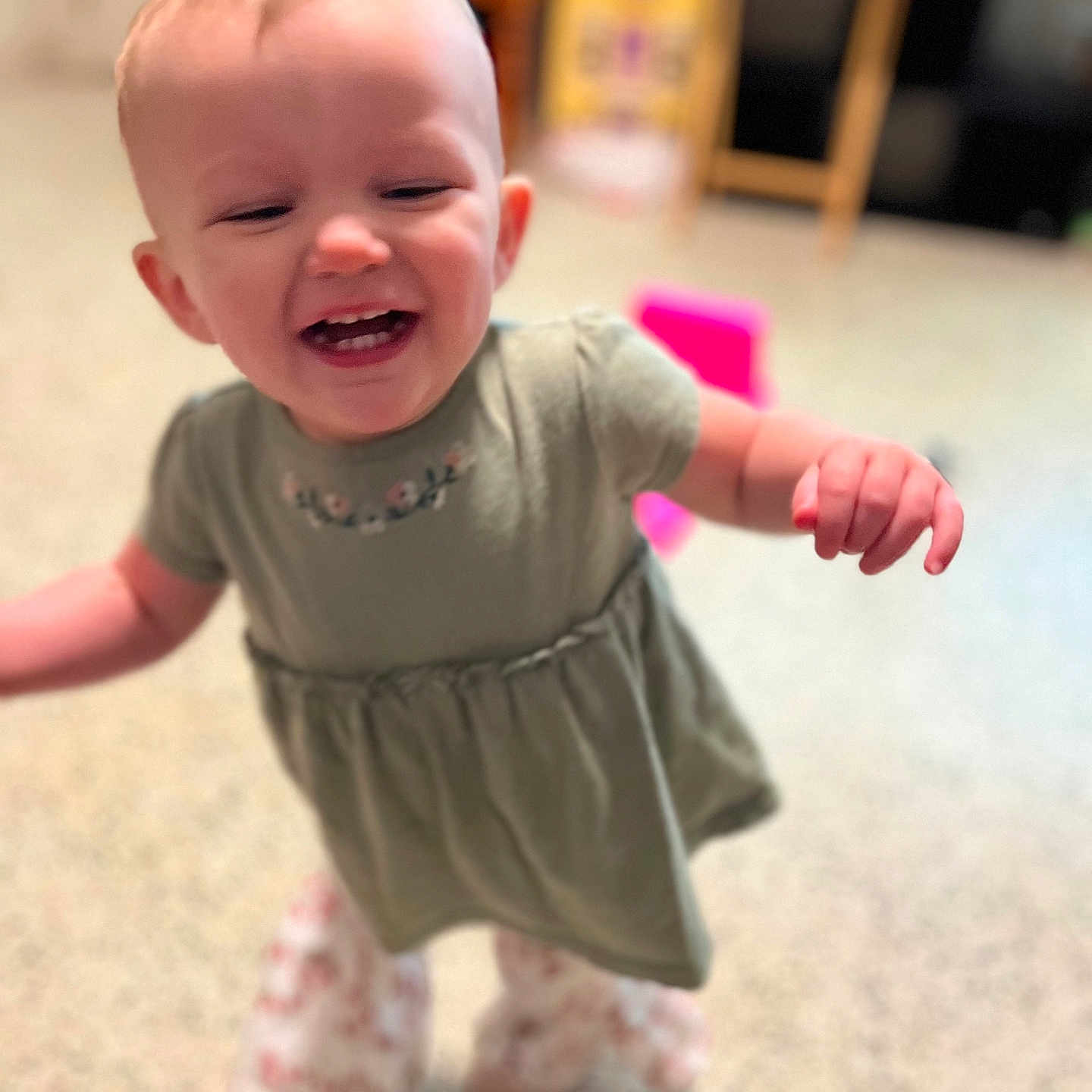 Tommie-Rose is registered to the contest to win money with this photo: baby, child, clothing, cute, dress, floor, fun, happy, home, indoor, joy, motion_blur, pants, person, play_area, smiling, standing, toddler, walking, young_child