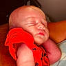 baby, sleeping, infant, red_clothing, arm, close_up, peaceful, skin, portrait, child, resting, indoors, person, sleep, newborn, cute, calm, human, baby_garment, toddler