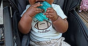 Zalyn joined the competition — help win amazing prizes! baby, child, stroller, teether, smiling, sitting, portrait, outdoor, bonnet, football, sportswear, white_shirt, patterned_pants, hands, face, eyes, happy, infant, baby_carriage, casual