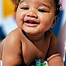 Zalyn is registered to the contest to win money with this photo: baby, infant, child, smiling, happy, portrait, close_up, curly_hair, pacifier, bare_shoulders, sitting, hands, face, teeth, indoor, colorful_background, photography, adorable, joyful, person