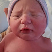 Avery joined the competition — help win amazing prizes! newborn, baby, infant, child, portrait, face, sleeping, eyes_closed, frown, hat, striped_hat, skin, bare_chest, hospital, blanket, bed, indoor, close_up, parent_hand, photography