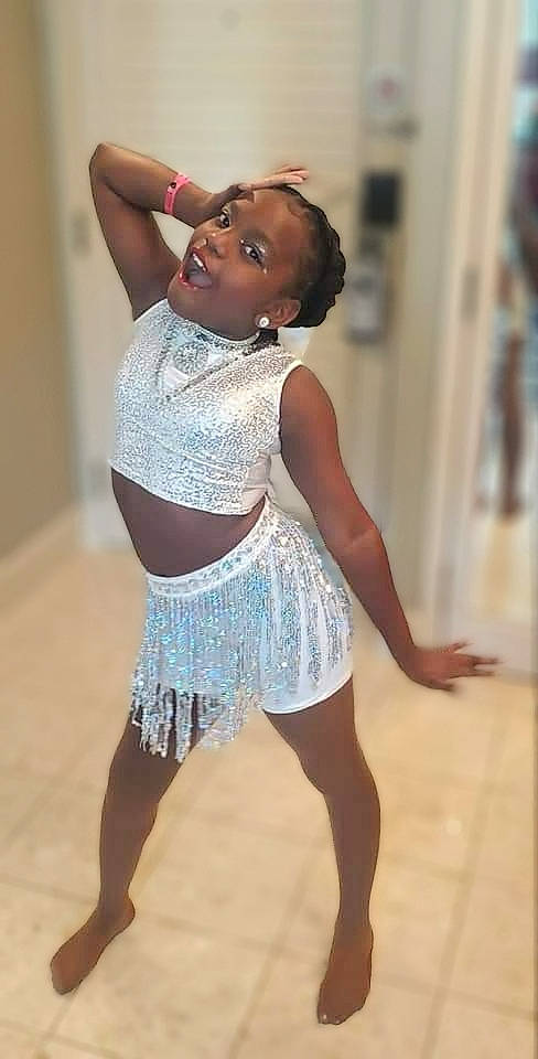 Za'Maria is registered to the contest to win money with this photo: abdomen, barefoot, chest, dance, entertainment, event, fashion_design, floor, flooring, happy, human_leg, joint, knee, navel, performing_arts, person, sleeve, smile, thigh, trunk