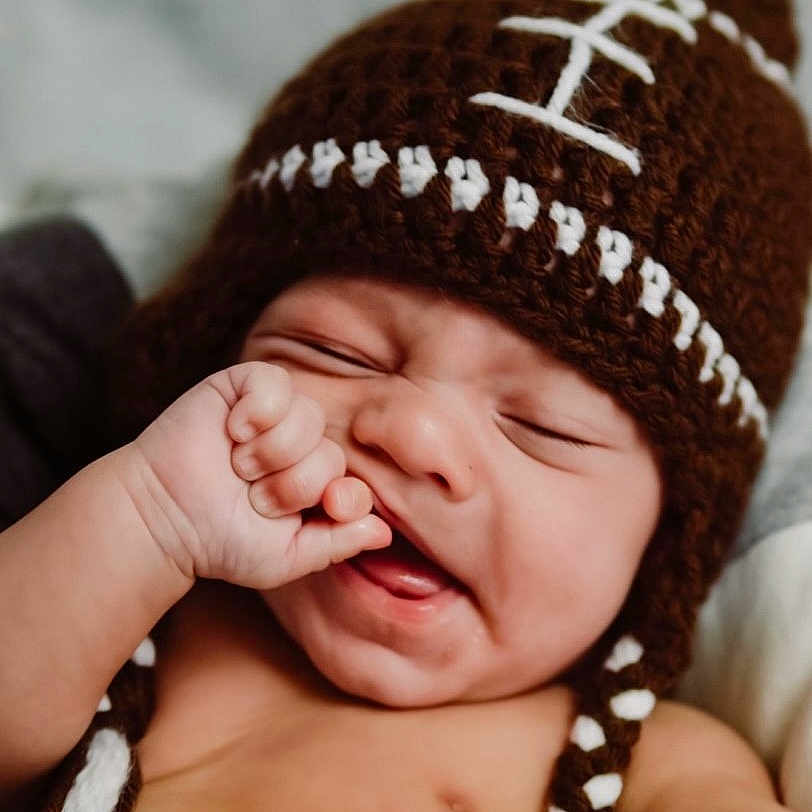 Ryker James is registered to the contest to win money with this photo: baby, beauty, cap, child, close_up, comfort, finger, flash_photography, gesture, hand, happy, headgear, human, jewellery, knit_cap, lip, nail, smile, thumb, toddler