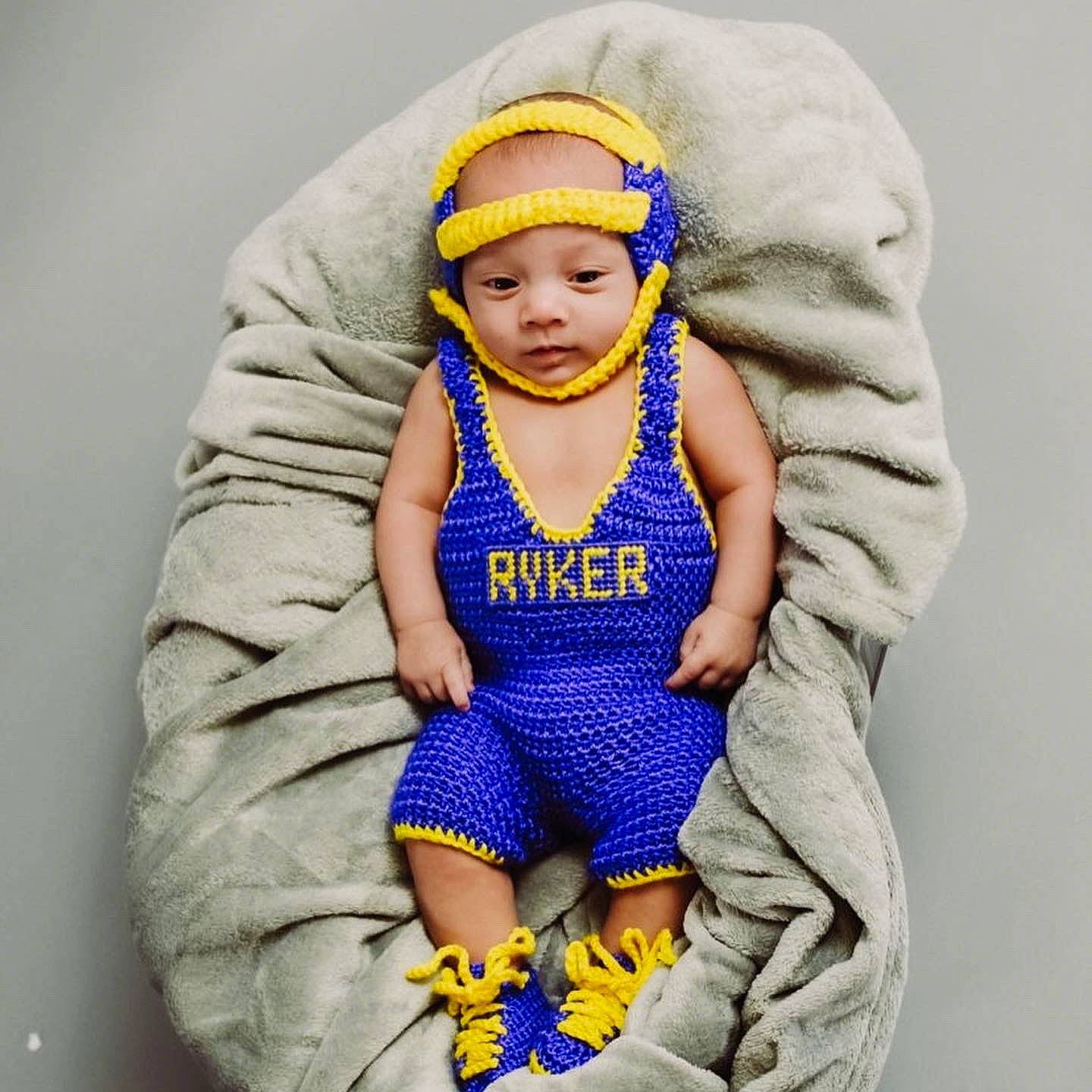 Ryker James is registered to the contest to win money with this photo: abdomen, arm, azure, baby, baby_products, baby_sleeping, baby_toddler_clothing, cap, comfort, electric_blue, face, happy, headgear, headwear, person, personal_protective_equipment, product, purple, sleeve, thumb