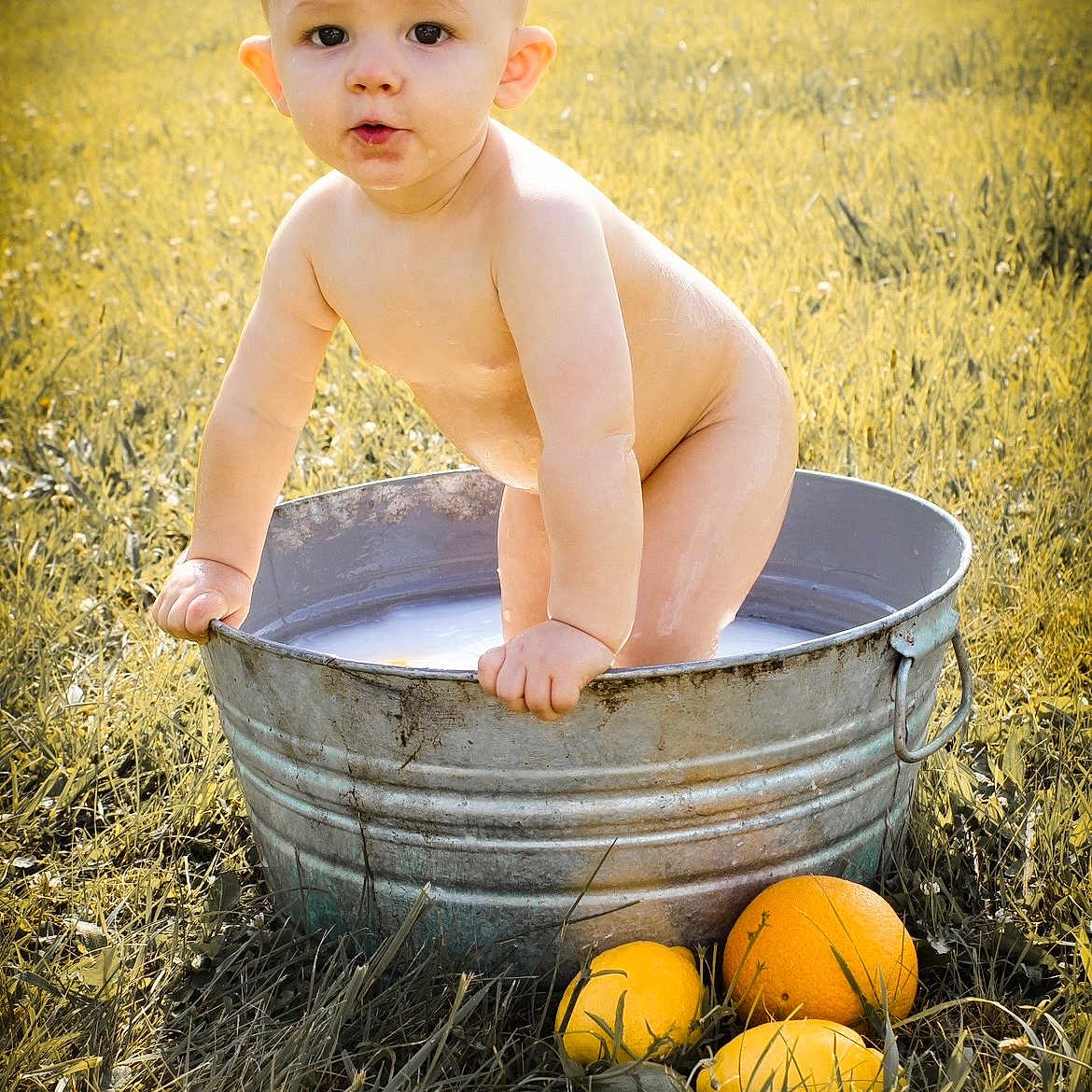 Elijah joined the competition — help win amazing prizes! baby, bare_skin, bath, child, citrus, curious, field, fruit, grass, lemon, metal_tub, nature, orange, outdoor, playful, standing, summer, sunlight, water, young