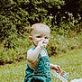 toddler, child, denim_overalls, cake, outdoor, greenery, grass, sign, happy_camper, birthday, food, frosting, table, celebration, summer, nature, cute, portrait, person, baby
