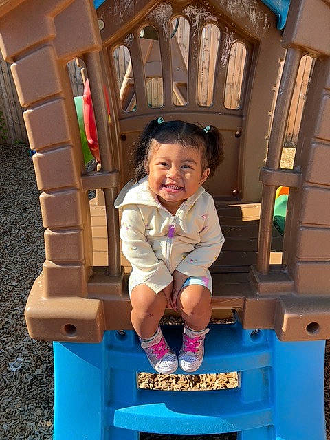 Jolie is registered to the contest to win money with this photo: baby_toddler_clothing, child, city, electric_blue, fun, happy, joy, leisure, outdoor_play_equipment, person, pink, play, playground, product, public_space, recreation, shorts, smile, snapshot, standing